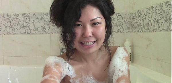  Asian beauty plays with pussy in the bathroom